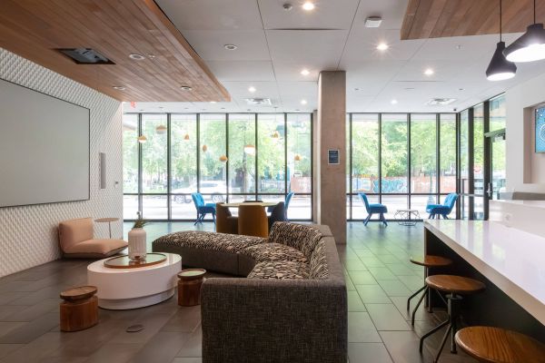 Skyloft Austin resident lounge with comfortable seating and floor-to-ceiling windows.