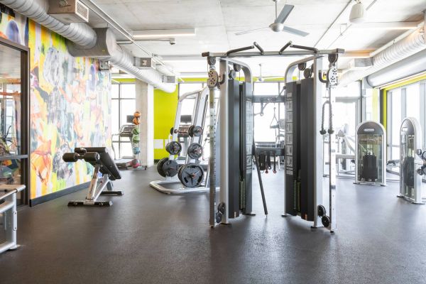 Skyloft Austin fitness center with strength-training equipment.